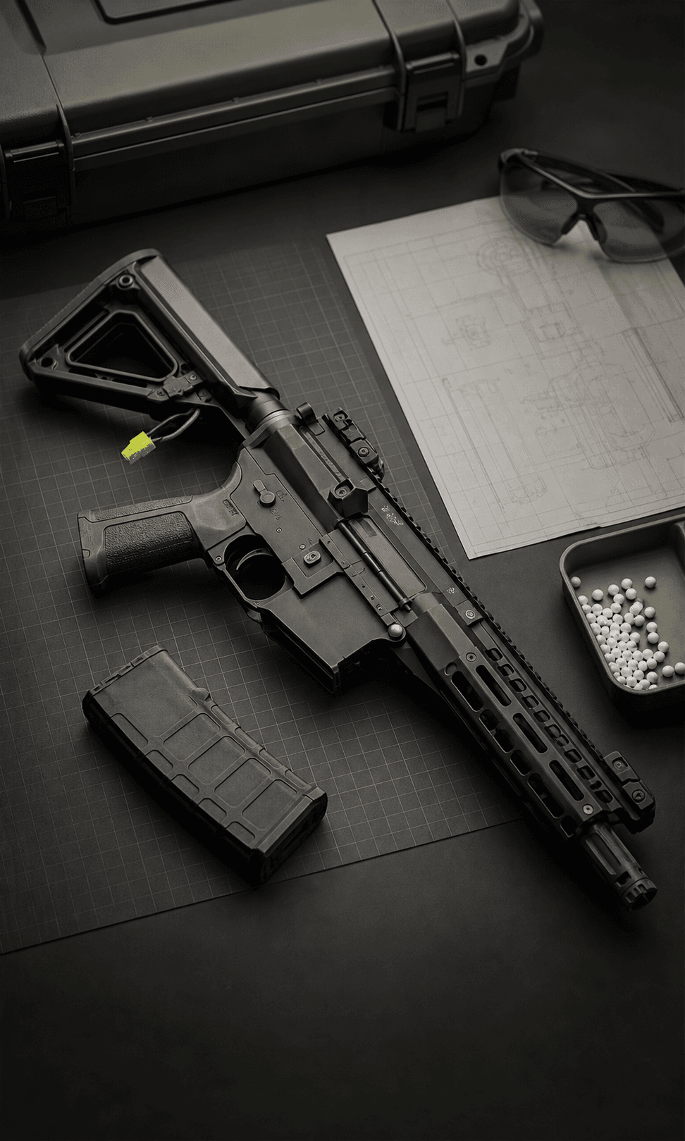 Airsoft replica, BBs and documentation on a technical workbench